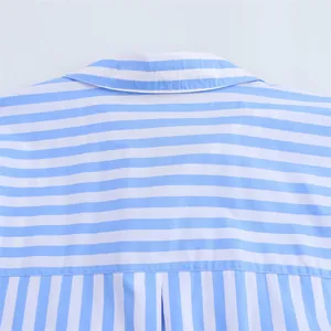 Detailed macro view of the light blue and white striped fabric on a casual shirt collar