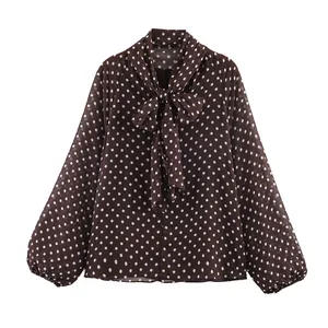 Stylish brown women's long sleeve blouse featuring white polka dots and bow tie neck