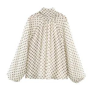Elegant white polka dot long sleeve blouse with high neck and puff sleeves detail view
