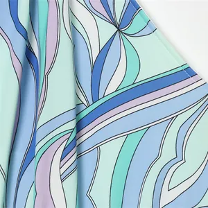 Close-up detail of summer halter mini dress with blue and purple geometric print fabric