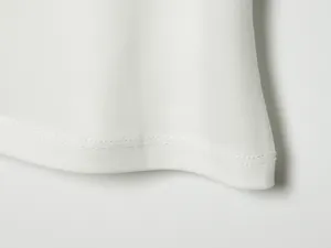 Detalle de cerca del dobladillo de doble costura de un vestido blanco de verano, textura