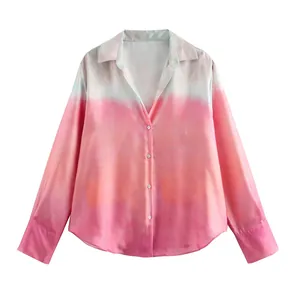Detail view of a trendy pink gradient tie-dye shirt featuring silky satin texture fabric