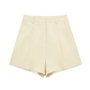 Detail view of high-waisted linen blend pleated shorts in cream for summer wear