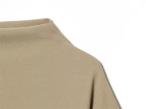 Macro view of beige mock neck top showing high-quality fabric texture and fine stitching