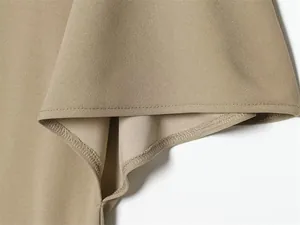Detailed close-up showing high-quality stitching and khaki fabric texture of asymmetric skirt