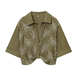 Olive green cropped shirt featuring white botanical leaf embroidery on the front.