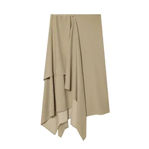 Detail view showing the elegant khaki asymmetric draped midi skirt with soft pleats