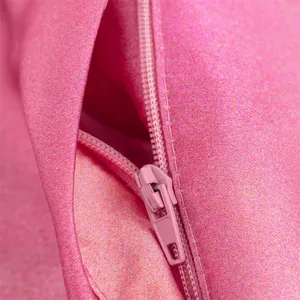 Detailed macro view of the vibrant pink satin fabric texture and matching zipper