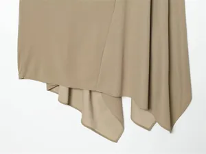 Macro view showing the soft drape and asymmetrical hemline of khaki skirt set