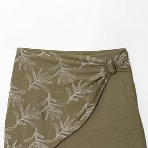 Chic olive green leaf print wrap skirt featuring a decorative antique ring buckle