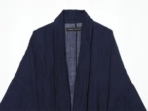 Detail showing navy crinkle texture and collar of semi-sheer summer jacket