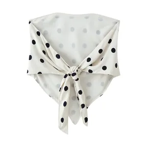 Close-up detail of white polka dot scarf bandeau top with a front knot design