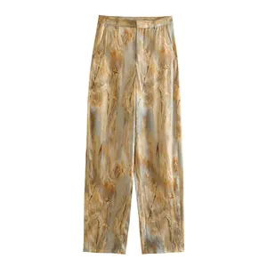 Detailed view of earth-toned marble print silk satin texture straight leg trousers