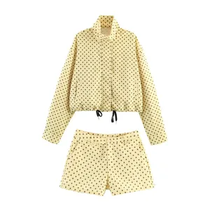 Close-up view of the yellow polka dot cropped jacket and matching shorts two-piece set