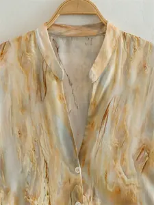 Macro view of tie-dye satin printed shirt with marble wood grain pattern and V-neckline