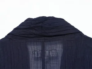 Detail view of navy semi-transparent fabric with wrinkled texture on a lightweight jacket