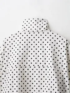 Detail shot of a white seersucker casual jacket collar with black polka dots pattern