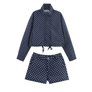 Detailed close-up showing the navy blue and white polka dot jacket and shorts set