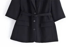 Detailed view of a black linen suit jacket featuring a waist belt and five-quarter sleeves