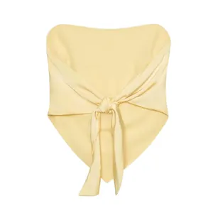Close-up detail of the stylish front-knot design on a minimalist cream tube top