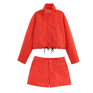 Full view of red and white polka dot two-piece set featuring cropped jacket and shorts