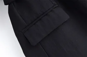 Close-up detail of the pocket and linen fabric texture on this black casual blazer