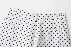 Detailed view of the back pockets and waist on white and black polka dot seersucker shorts