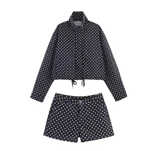 Stylish two-piece set featuring a black and white polka dot cropped jacket and shorts