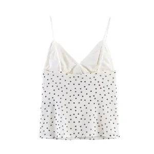 Detailed view of white mesh camisole with black polka dots and lace trim