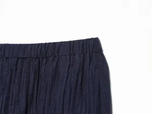 Macro view of navy blue elastic waistband showing delicate crinkle texture on fabric