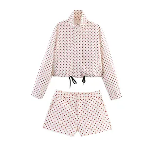 Two-piece set with red polka dot cropped jacket and matching high-waisted shorts