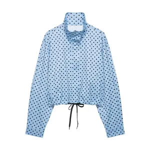 Front view of light blue polka dot seersucker jacket featuring a drawstring waist detail