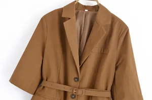 Detailed view of the textured brown linen blazer with lapel and matching waist belt.