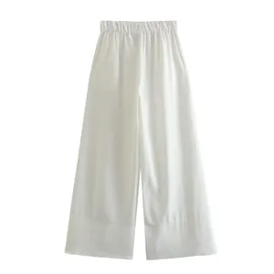 Detailed view of white high-waisted wide-leg trousers featuring a comfortable elastic waist