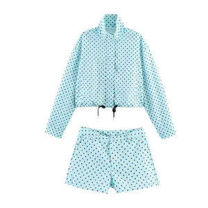 Two-piece light blue polka dot set with a long-sleeved jacket and matching shorts