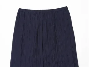 Close-up of navy blue semi-sheer pants featuring an elastic waistband and crinkle texture.