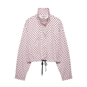 Stylish pink polka dot cropped jacket for women with stand collar and drawstring hem detail.