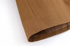 Detail of brown linen fabric hem with neat stitching and smooth lining