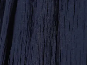 Detailed macro view of navy blue fabric with a unique crinkle and wrinkled texture