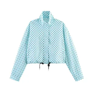 Close-up detail of a light blue polka dot cropped windbreaker jacket with adjustable drawstring