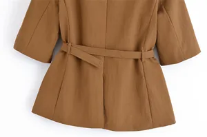 Detailed back view of a brown linen blazer showing the adjustable waist belt and texture