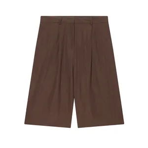 Detailed view of brown linen casual mid-waist wide-leg shorts with pleated design