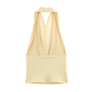 Back view detail of a beige halter top featuring a secure neck button closure mechanism
