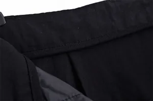 High-quality macro detail showing precise stitching and lining on black linen fabric shorts