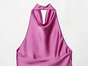 Detalle de un top de satén rosa con cuello halter que muestra la textura de la tela