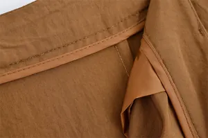 Close-up of premium brown linen fabric showing neat interior stitching and lining details