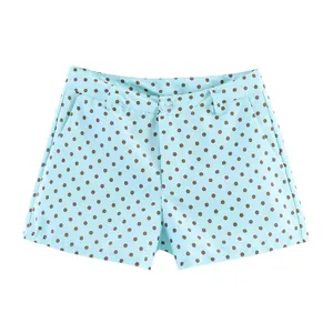 Detail view showing light blue summer shorts with brown polka dots and button closure.