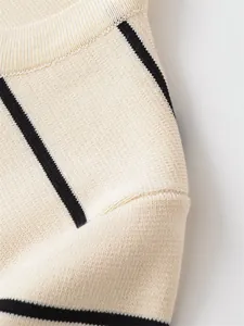 Detailed macro shot of fine knit cream and black striped short sleeve top texture