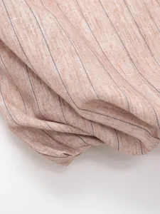 Detailed macro view of French style striped fabric with peach melange and navy stripes