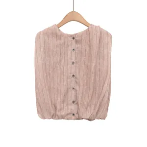 Detail of a French style striped sleeveless top with button-down front and gathered hem.